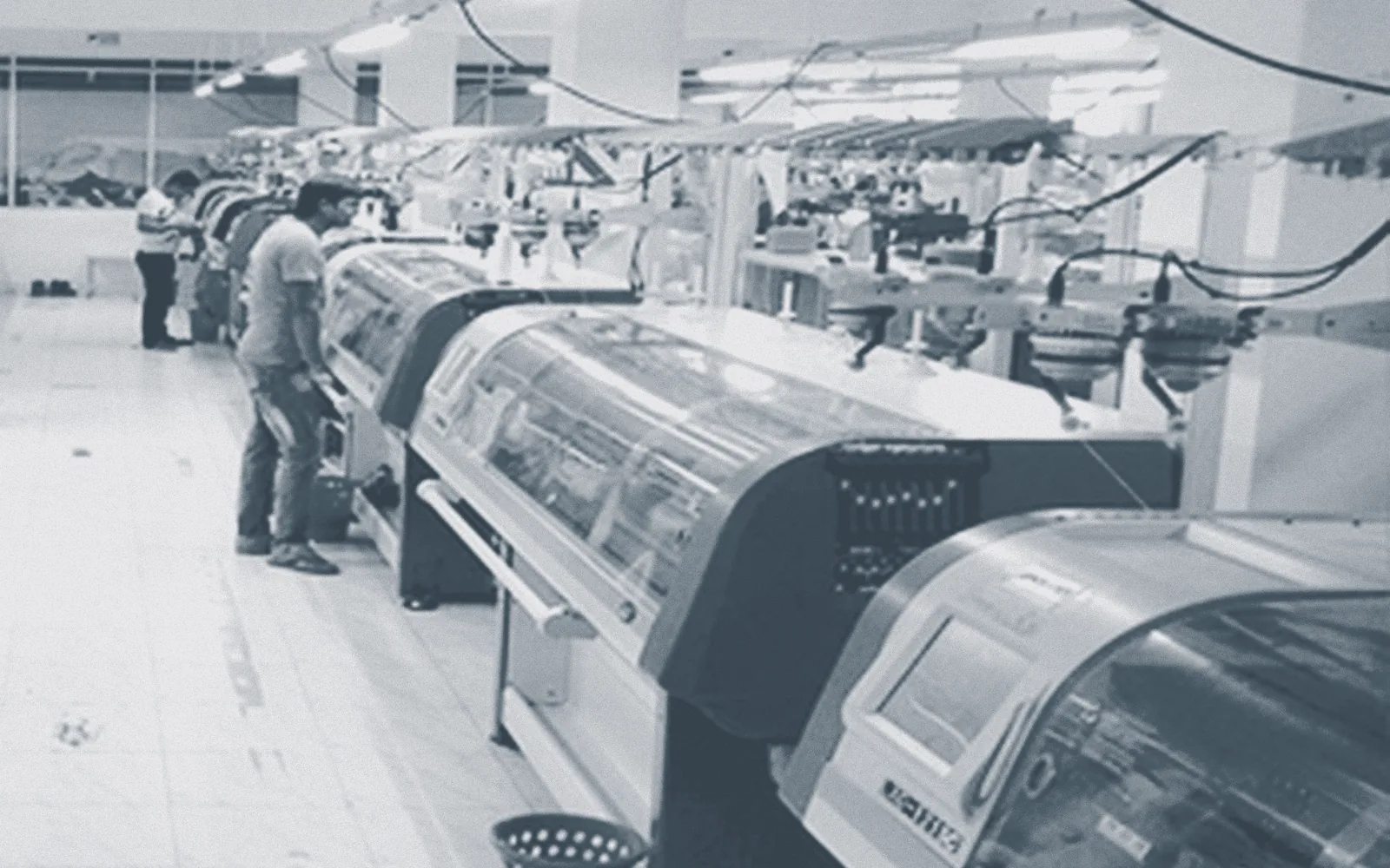 Rows of automatic flat knitting machines on the knitting floor